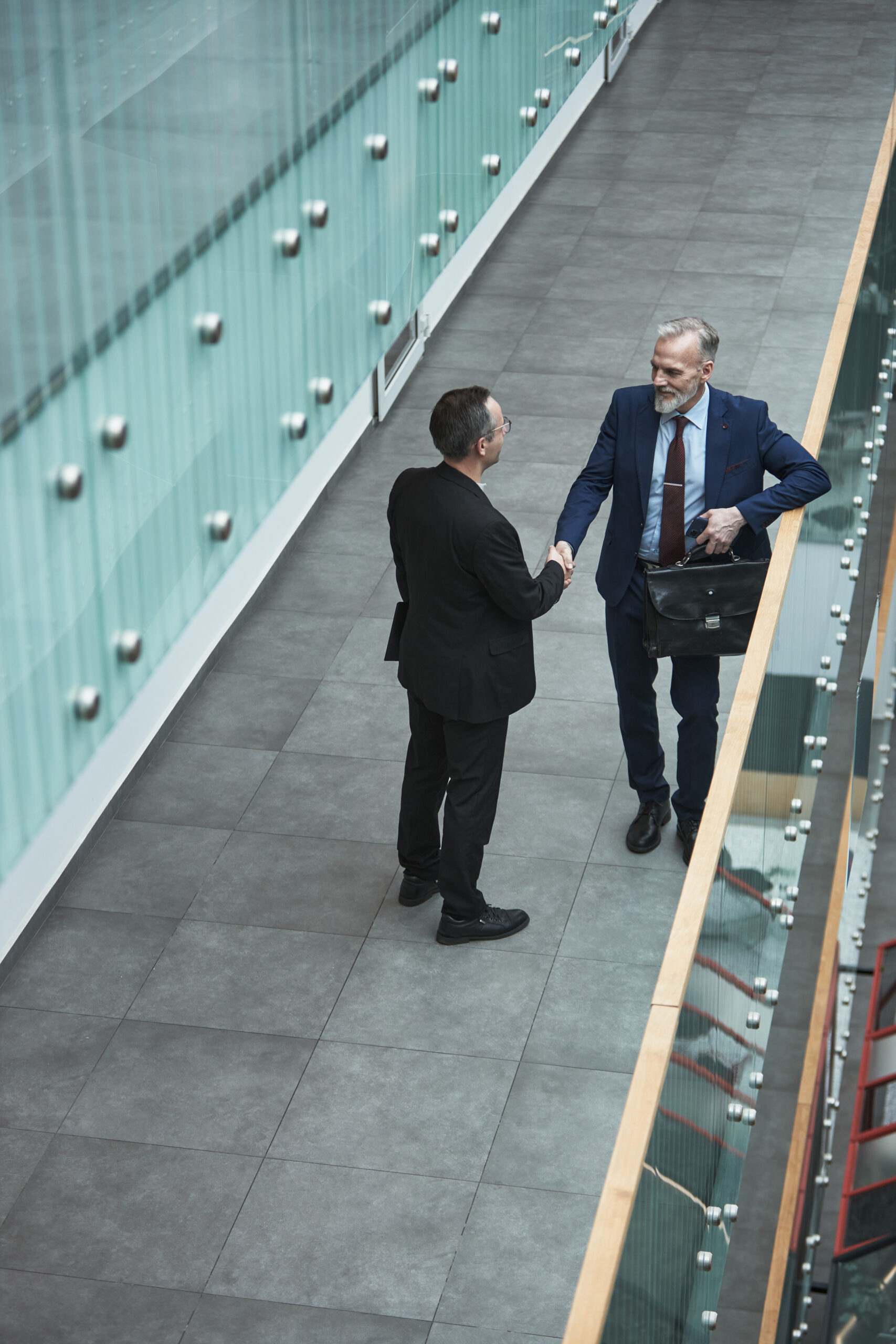 businessmen shaking hands in corporate hallway 2025 07 05 06 15 18 utc scaled.jpg